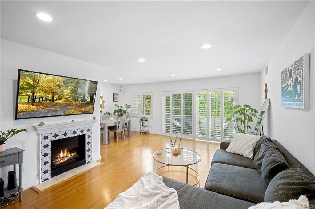 a living room with furniture a flat screen tv and a fireplace