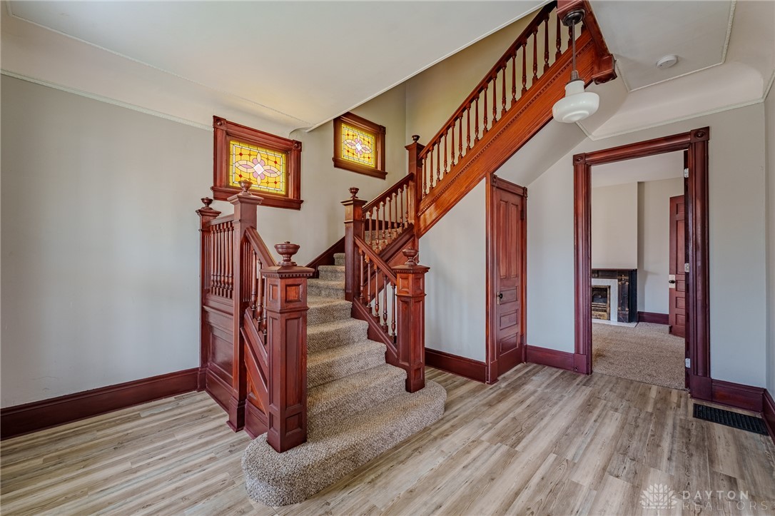 308 Yankee Road Middletown, OH 45044 - Photo 10 of 47 This grand wooden staircase with stained glass windows offers a dramatic entry to the home.