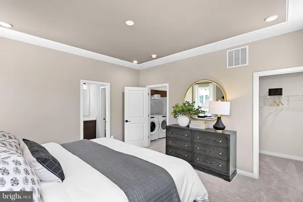 a bedroom with a bed and a dresser