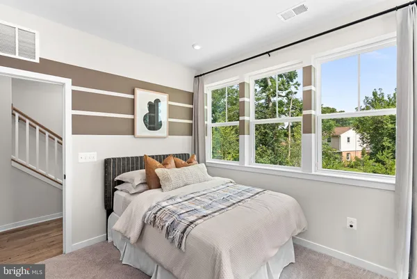 a bedroom with a large bed and a large window