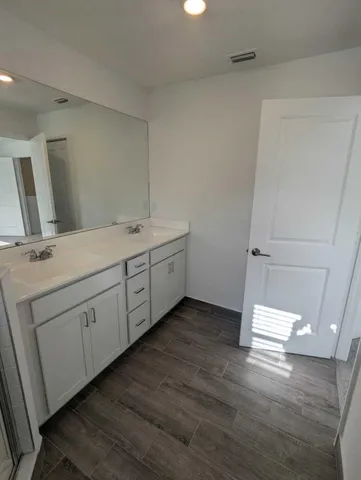 a room with a sink and mirror