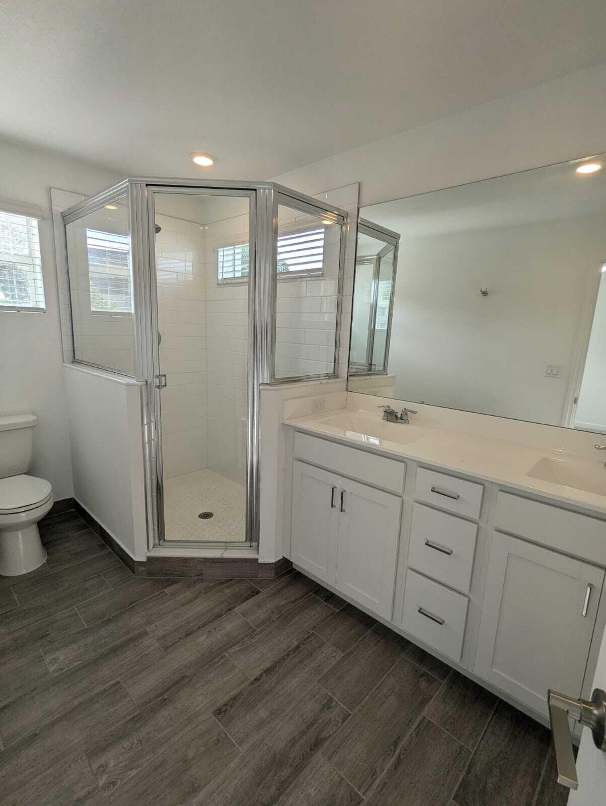 4351 Pond Lily Lane Lake Worth, FL 33467 - Photo 15 of 26 a spacious bathroom with double vanity sink a mirror and a toilet