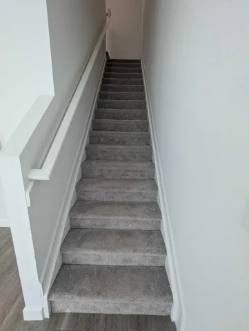 a view of a white house with a small yard and a large window