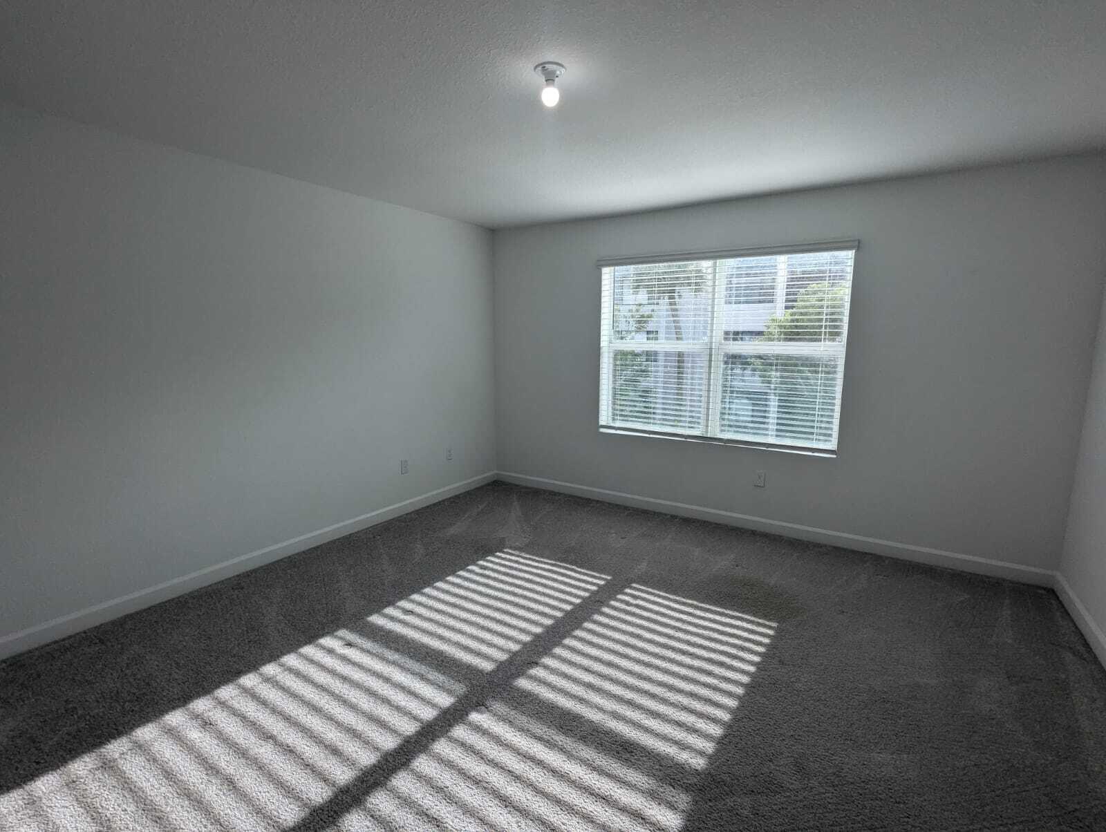 4351 Pond Lily Lane Lake Worth, FL 33467 - Photo 19 of 26 an empty room with wooden floor and windows