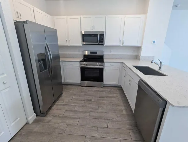 a view of a bedroom with wooden floor and closet