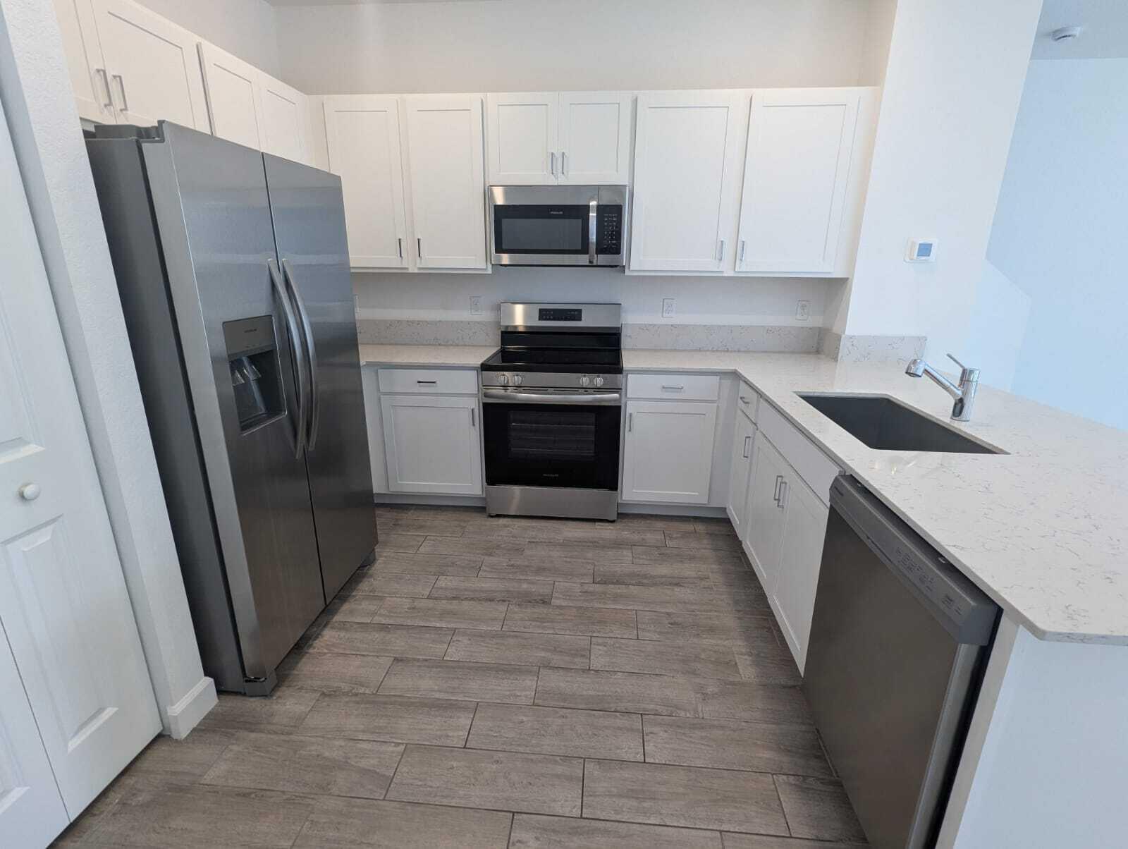 4351 Pond Lily Lane Lake Worth, FL 33467 - Photo 21 of 26 a kitchen with a refrigerator sink and microwave