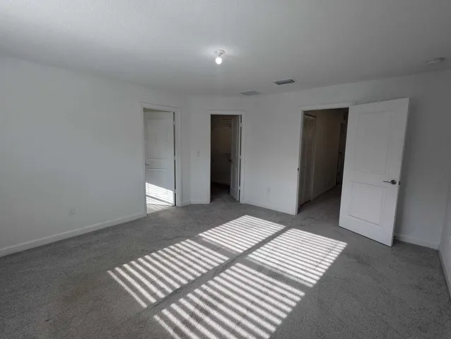 an empty room with closet area