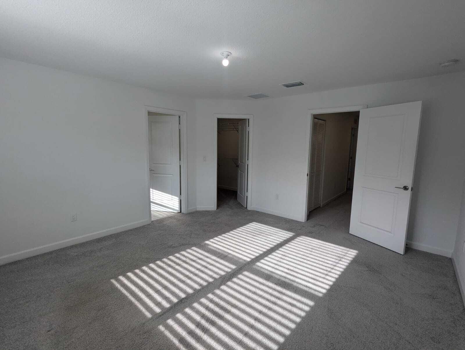 4351 Pond Lily Lane Lake Worth, FL 33467 - Photo 22 of 26 a view of a bedroom with wooden floor and closet