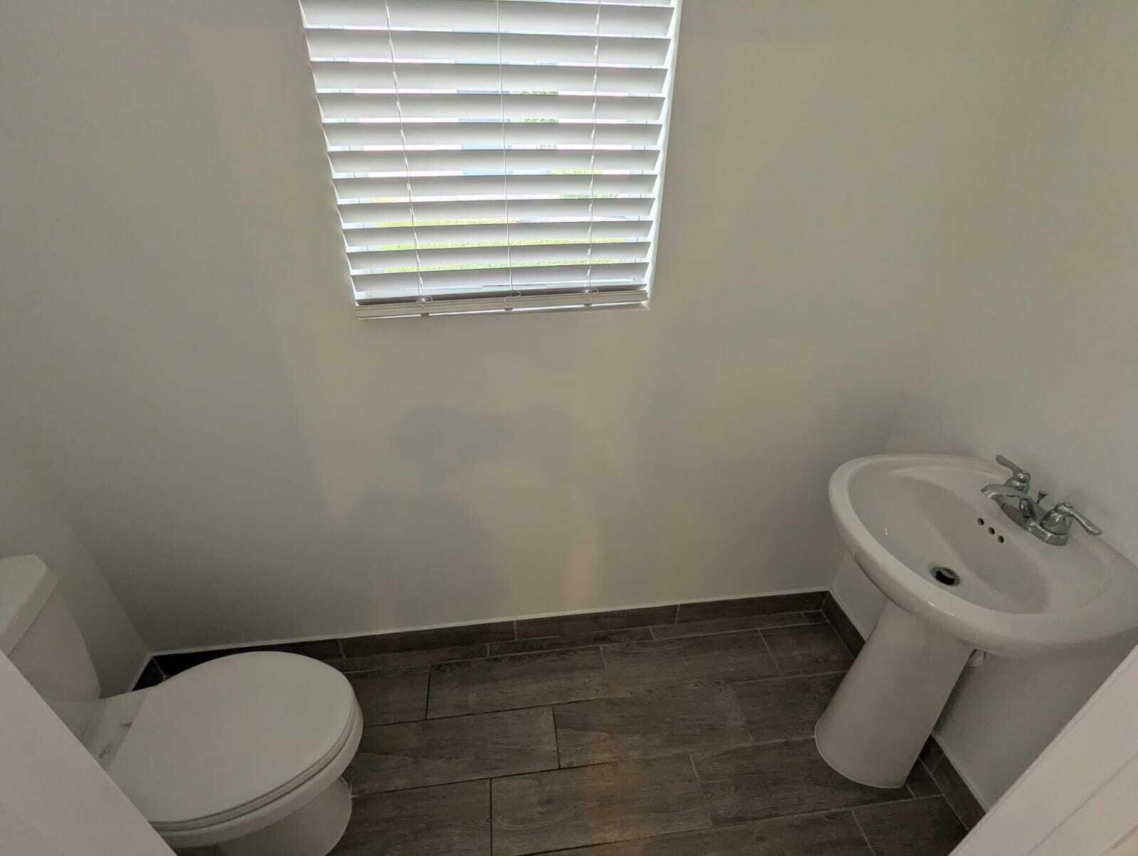 4351 Pond Lily Lane Lake Worth, FL 33467 - Photo 5 of 26 a white toilet sitting next to a white sink