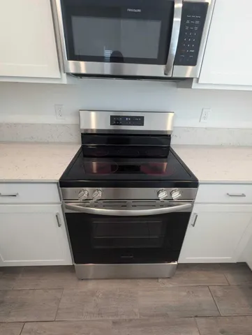 a stove top oven sitting inside of a kitchen