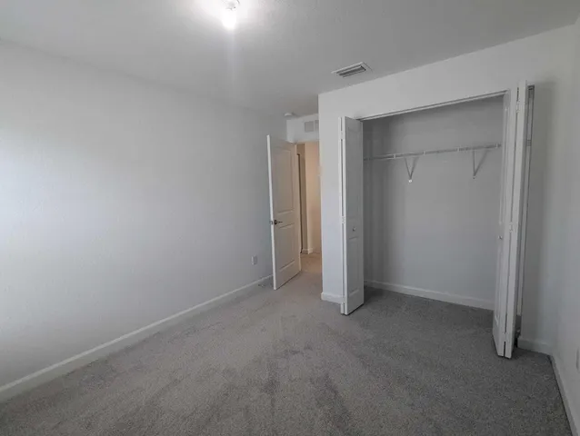 an empty room that has a grey walls