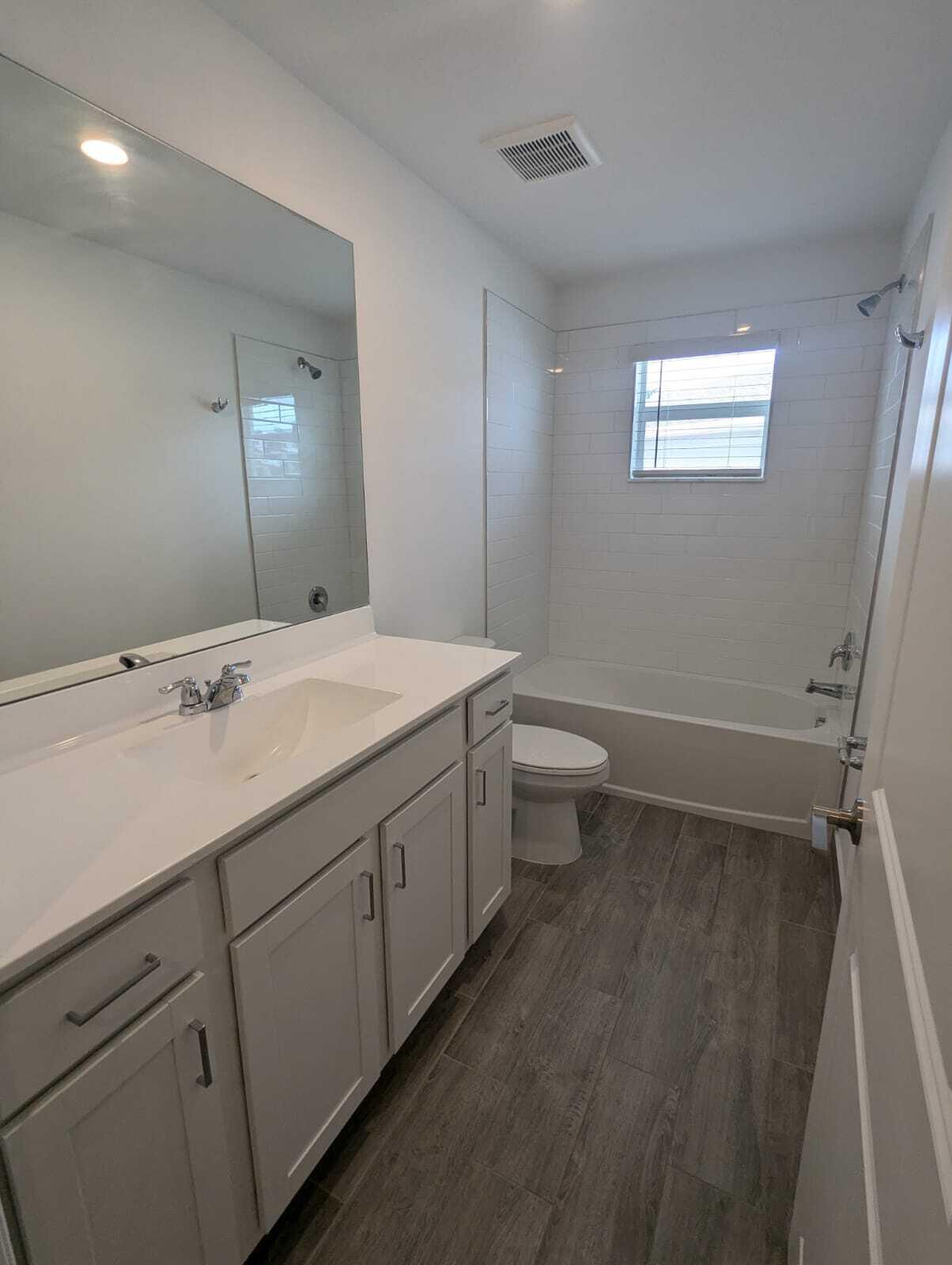 4351 Pond Lily Lane Lake Worth, FL 33467 - Photo 10 of 26 a bathroom with a double vanity sink and a mirror