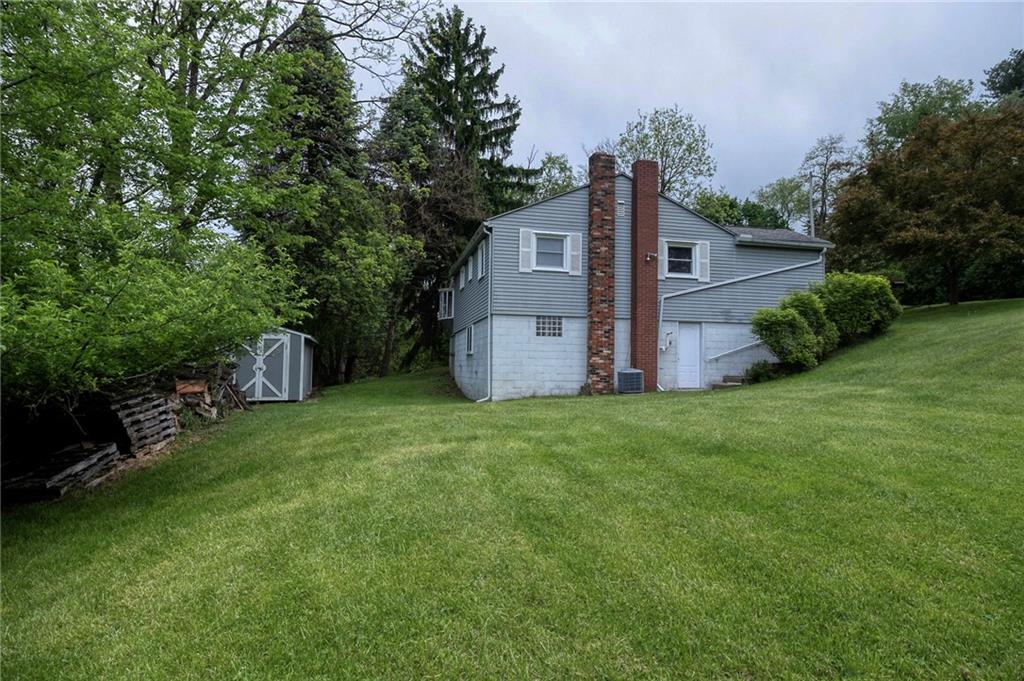 531 Laughlin Avenue Pittsburgh, PA 15210 - Photo 28 of 35 a view of a backyard with potted plants and large trees