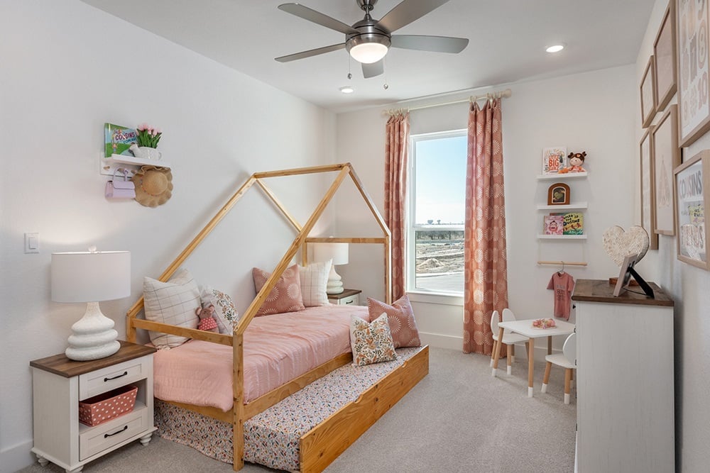 1804 Plum Tree Way Georgetown, TX 78628 - Photo 19 of 30 a bedroom with a bed and a chandelier