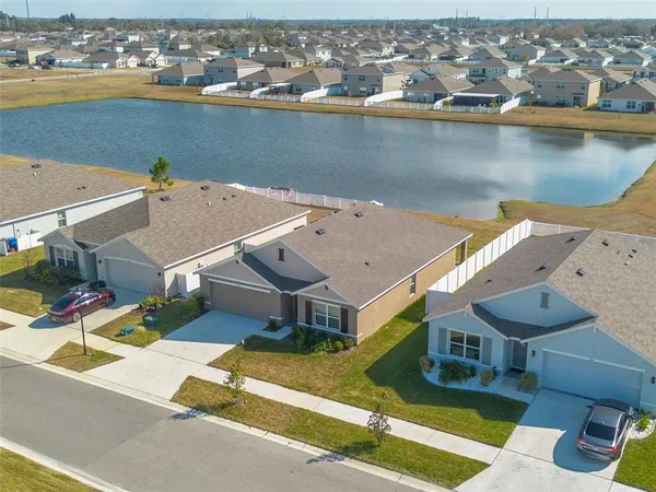 an aerial view of a house with a lake view