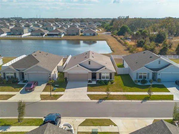 an aerial view of a house with a lake view