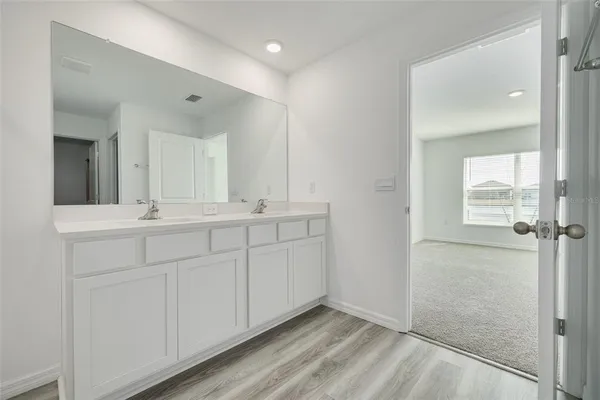 a bathroom with a double vanity sink and mirror