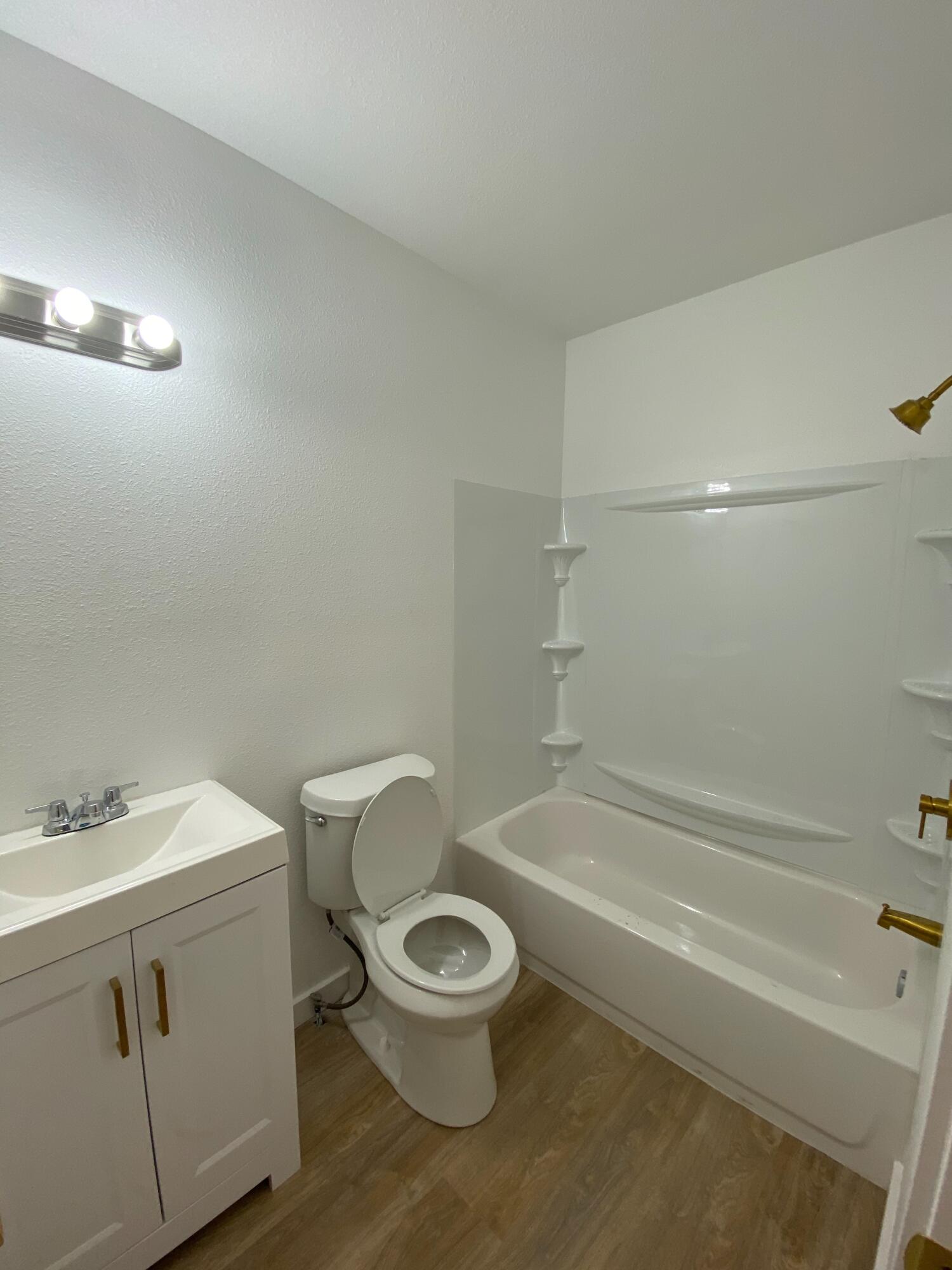 2017 17th Street, Unit REAR Lubbock, TX 79401 - Photo 8 of 9 a white toilet sitting next to a bath tub