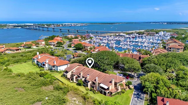 an aerial view of lake and residential houses with outdoor space