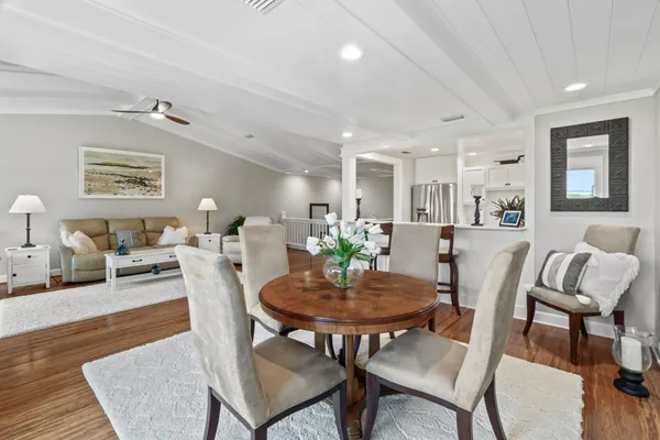 a kitchen with granite countertop a sink a stove and cabinets