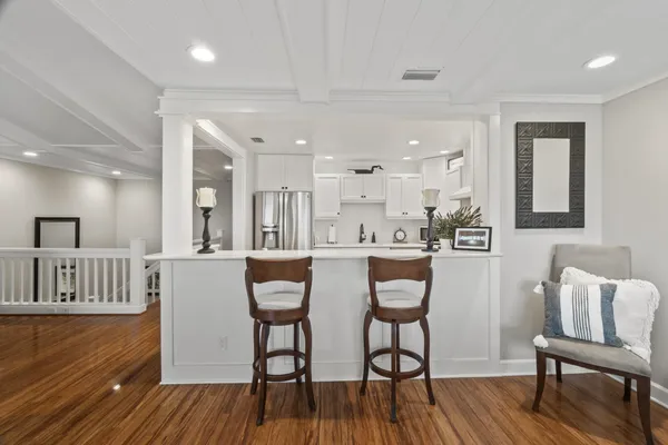 a bathroom with a granite countertop sink a potted plant and a large mirror