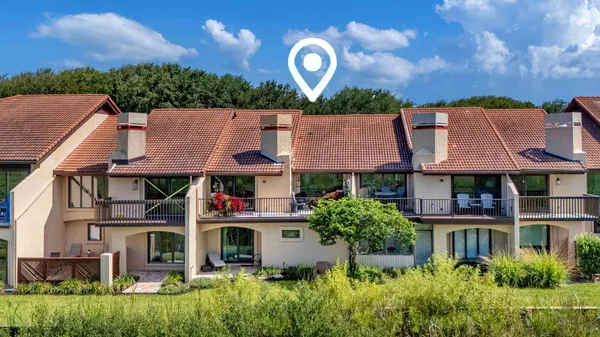 a view of a chairs and table in the balcony