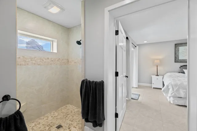 a view of a city with lots of residential buildings ocean and mountain view in back