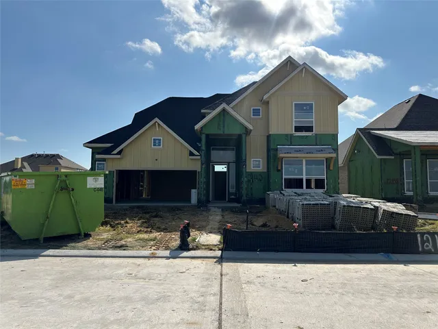 a front view of a house with a garden and yard