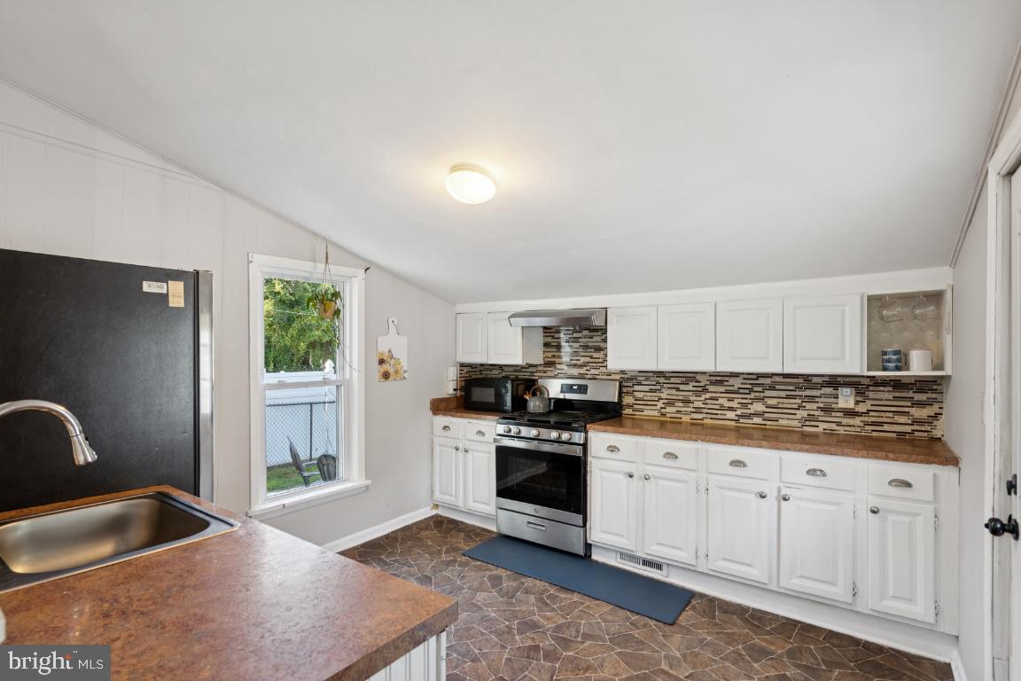 344 Raritan Avenue Atco, NJ 08004 - Photo 15 of 26 a kitchen with granite countertop a stove sink and cabinets