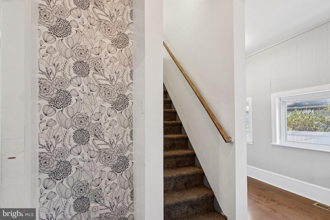 344 Raritan Avenue Atco, NJ 08004 - Photo 7 of 26 a view of a hallway with wooden floor and stairs