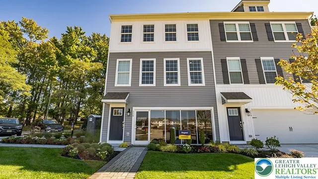 a front view of a house with garden and porch