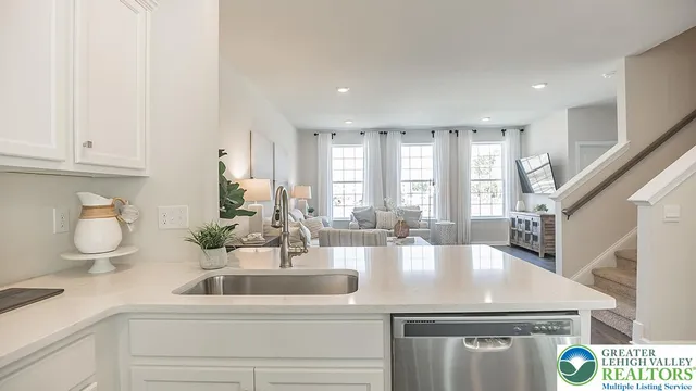 a kitchen with kitchen island a sink and a stove with wooden floor