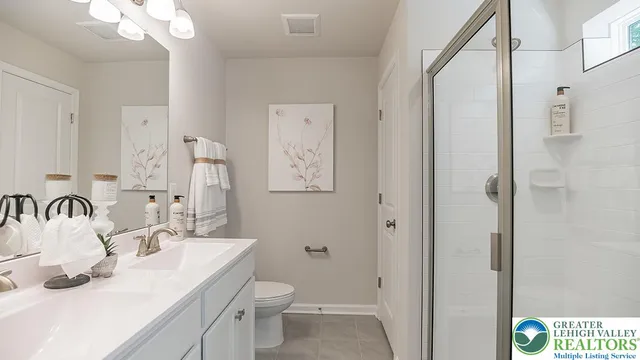 a bathroom with a sink a toilet and a mirror