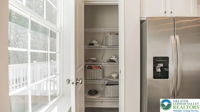 a kitchen view with a refrigerator and cabinets