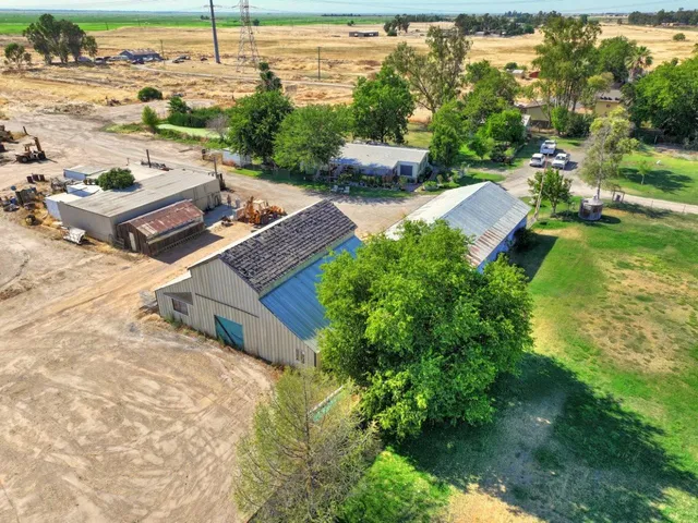 an aerial view of a house with garden space and lake view