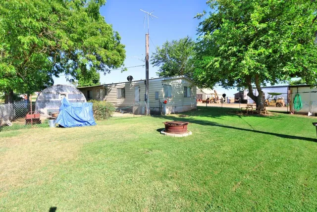 a view of a house with backyard and sitting area