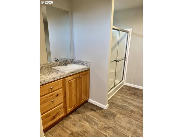 a bathroom with a shower and a glass door
