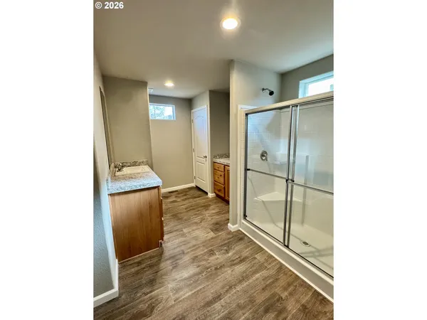 a bathroom with a granite countertop sink a toilet a mirror and bathtub