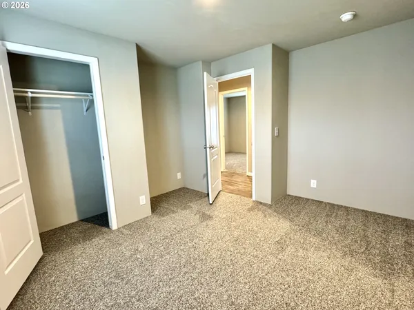 an empty room with closet and wooden door