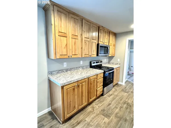 a kitchen with a stove a sink and a microwave