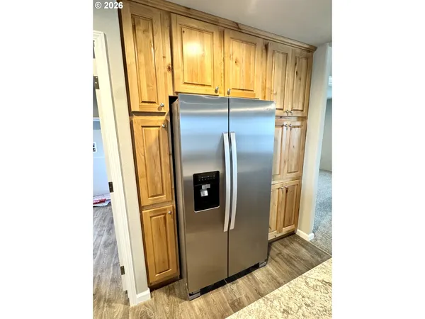 a kitchen with a refrigerator and window