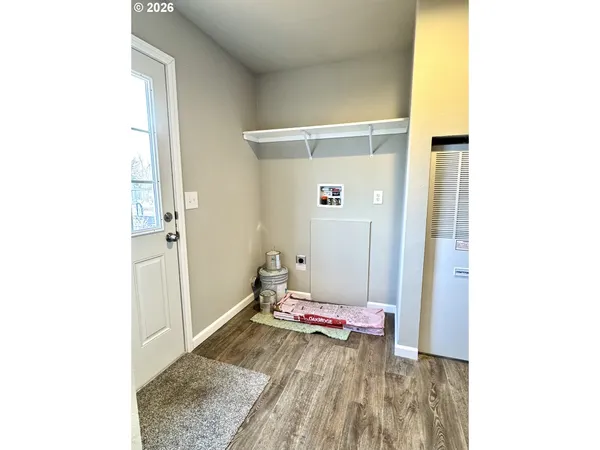 a view of a kitchen with wooden floor and more cabinets