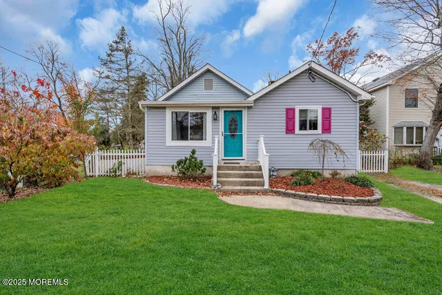 a front view of house with yard and green space