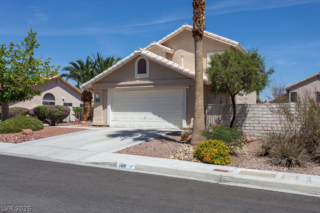 1416 Walstone Road North Las Vegas, NV 89031 - Photo 39 of 47 An inviting exterior with a concrete driveway leading to the attached garage, complemented by desert-friendly landscaping.