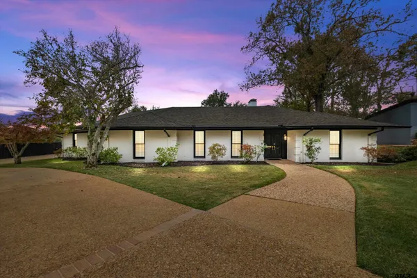 a front view of a house with a garden and porch