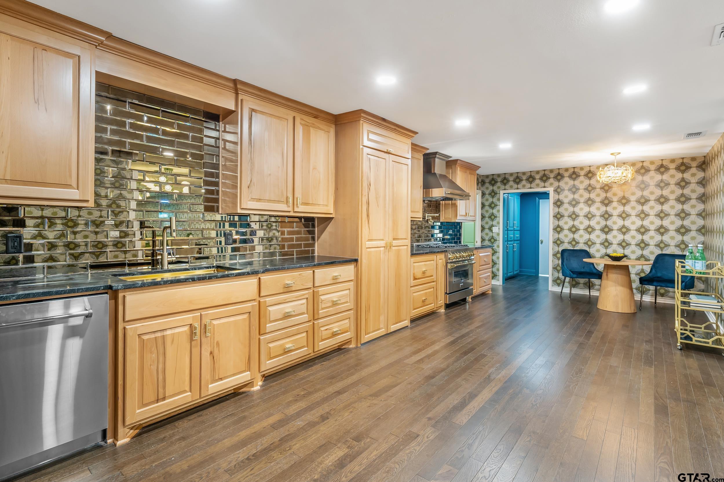 606 Tremont Place Tyler, TX 75701 - Photo 12 of 48 a kitchen with lots of counter top space and wooden floor
