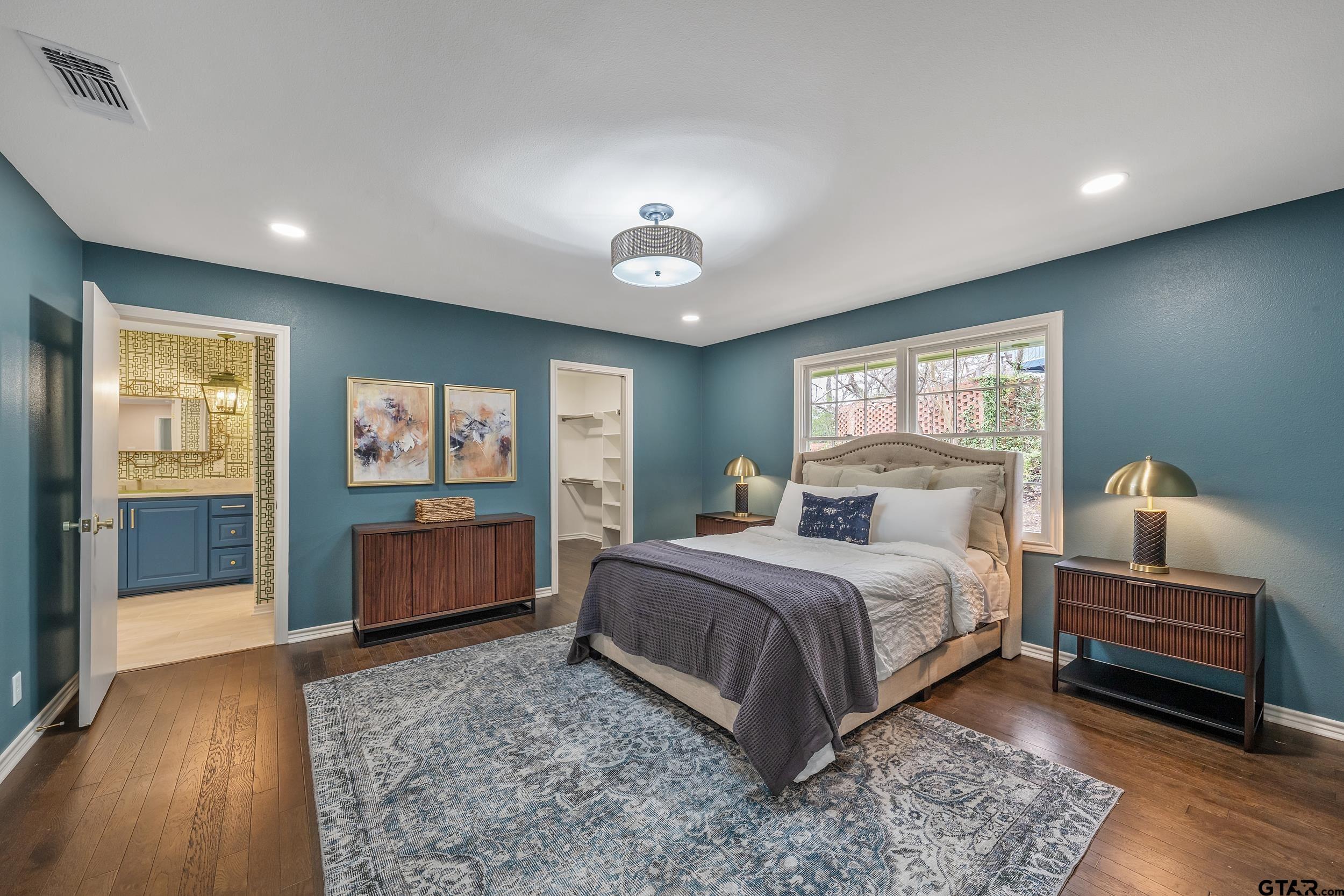 606 Tremont Place Tyler, TX 75701 - Photo 34 of 48 a bedroom with a bed and a view of bathroom