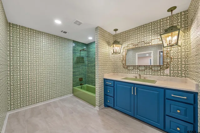 a bedroom with a large bed and a night stand