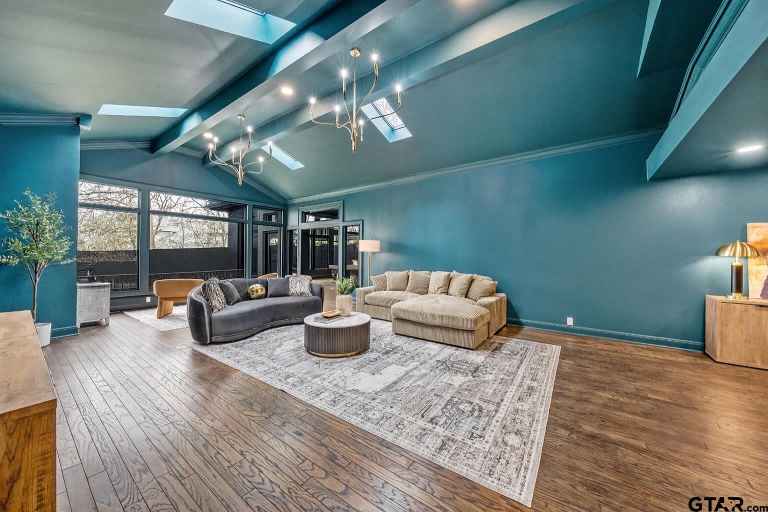 606 Tremont Place Tyler, TX 75701 - Photo 4 of 48 a living room with furniture a chandelier and a rug
