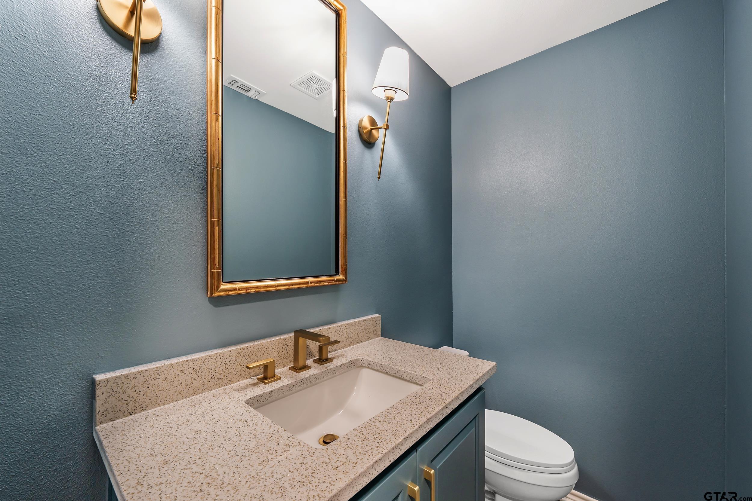 606 Tremont Place Tyler, TX 75701 - Photo 41 of 48 a bathroom with a sink toilet and mirror